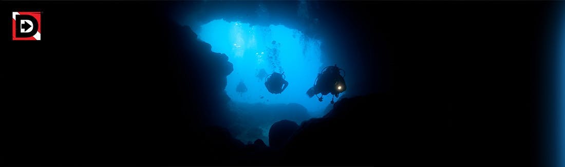 divers entering a cave 